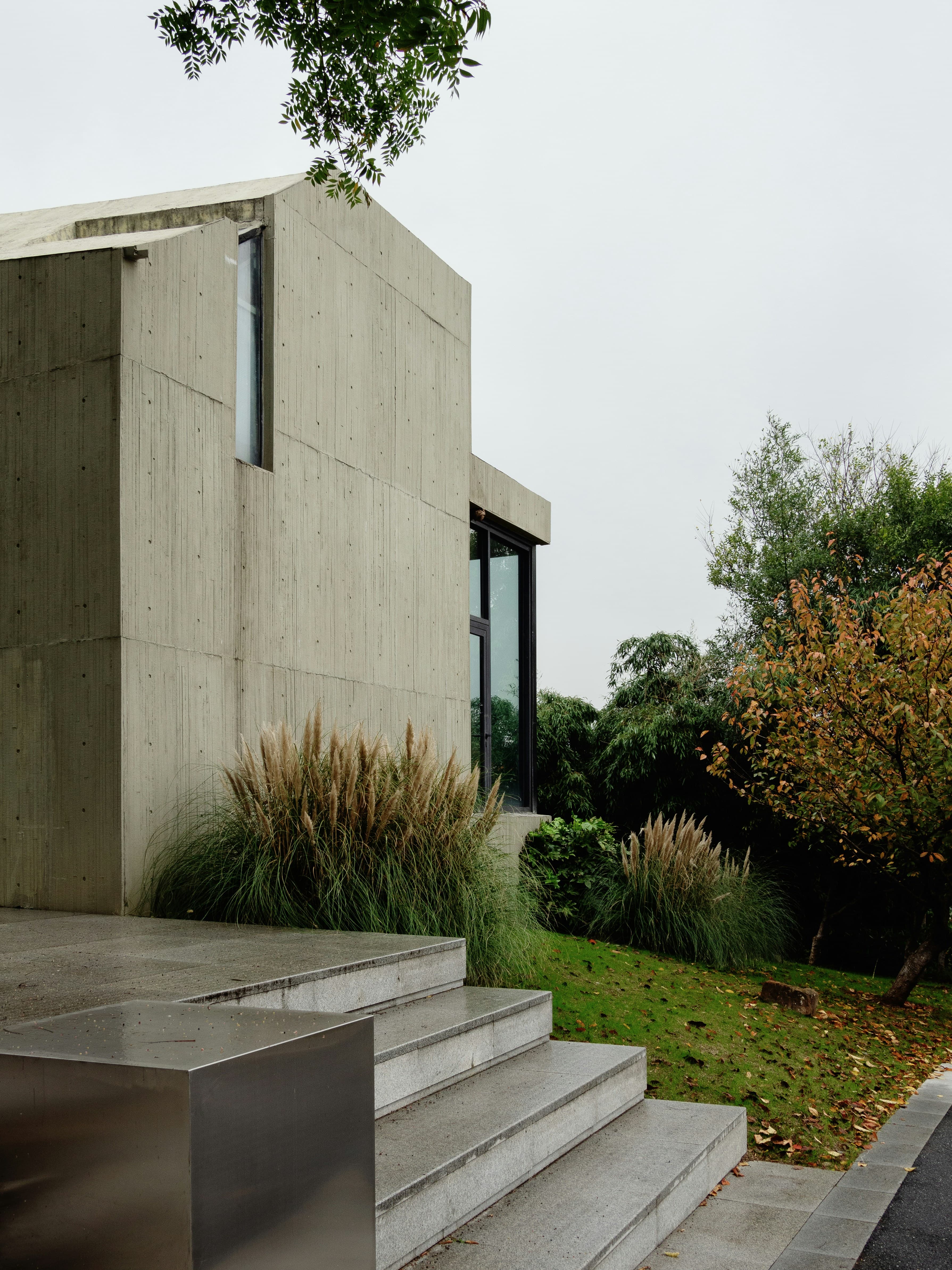 Board marked concrete studio with steps and grasses