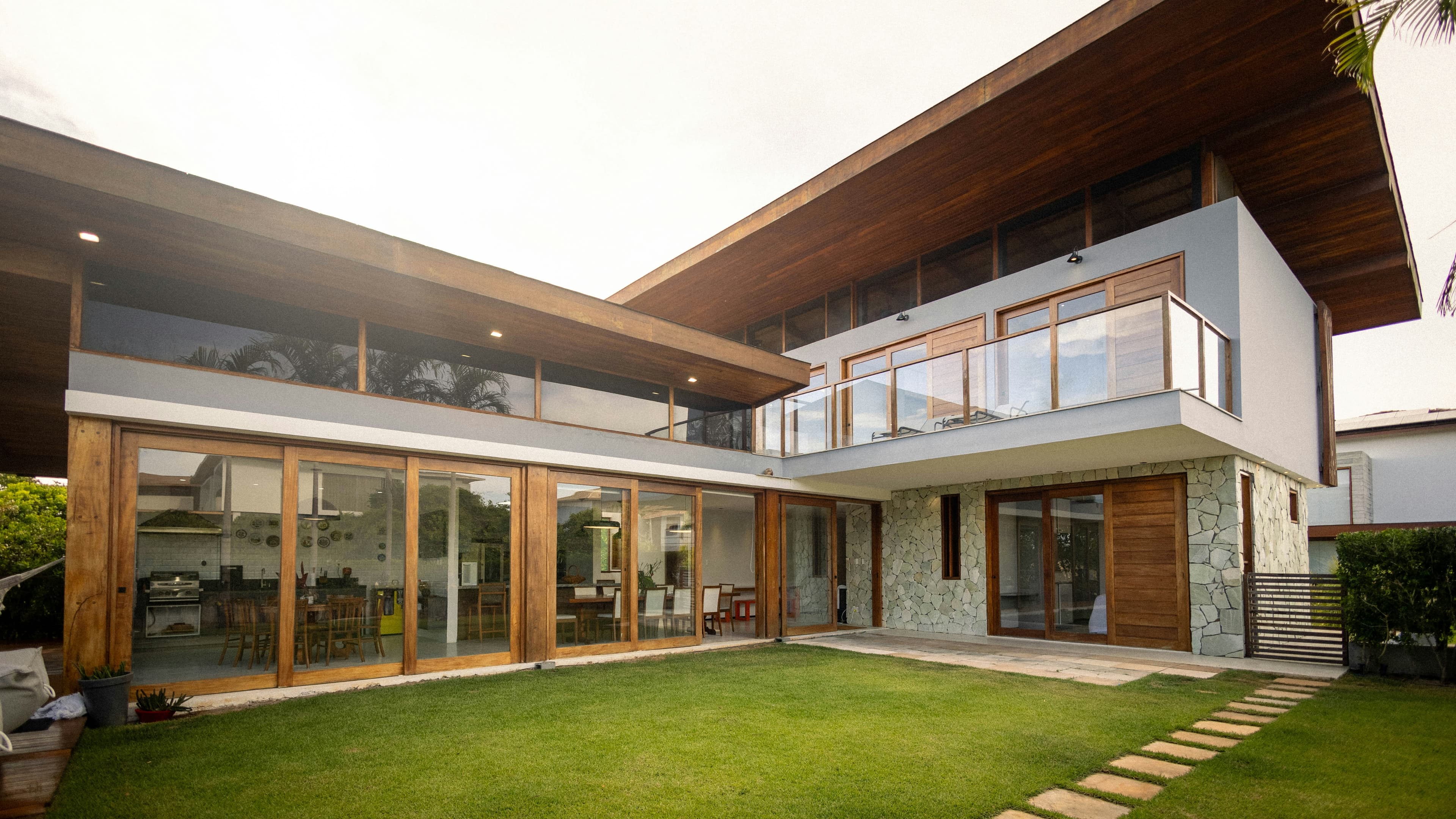Modern house with large windows and a timber soffit over a lawn